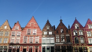 Roofs like this, called a stepped-gable, are present in cities that were prominent in the County of Flanders (e.g. Lille, Bruges, Ghent)